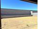 Large dirt backyard enclosed with block wall, offering privacy and space for customization at 22507 W Pontiac Dr, Surprise, AZ 85387