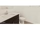 Modern bathroom features a sleek vanity with chrome faucet and a white toilet at 22507 W Pontiac Dr, Surprise, AZ 85387