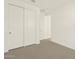 Bedroom with carpet and large mirrored closet at 22507 W Pontiac Dr, Surprise, AZ 85387