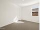 Carpeted Bedroom with a window and a white door at 22507 W Pontiac Dr, Surprise, AZ 85387