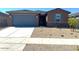 Charming single-story home featuring low maintenance desert landscaping and a convenient two-car garage at 22507 W Pontiac Dr, Surprise, AZ 85387