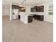 Open-concept kitchen features modern cabinetry, a center island, and stainless appliances at 22507 W Pontiac Dr, Surprise, AZ 85387