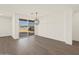 Open concept living area with wood look tile flooring and sliding glass doors to the back yard at 22507 W Pontiac Dr, Surprise, AZ 85387