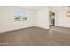 Open living room with hardwood floors, a large window, and glass sliding doors at 22507 W Pontiac Dr, Surprise, AZ 85387
