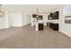 Expansive view of an open living space featuring hardwood floors leading to a modern kitchen at 22507 W Pontiac Dr, Surprise, AZ 85387