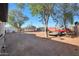 Large backyard with gravel, mature trees, and storage shed at 3206 W Garfield St, Phoenix, AZ 85009