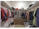 Well-organized walk-in closet with double hanging rods and shelves at 3206 W Garfield St, Phoenix, AZ 85009