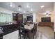 Open concept kitchen and living area with dark wood cabinets and a brown couch at 3206 W Garfield St, Phoenix, AZ 85009