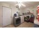 Laundry room with washer, dryer, and ample storage at 3206 W Garfield St, Phoenix, AZ 85009