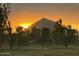 Scenic sunset view on the golf course showcasing lush fairways and sprinkler systems at 3500 N Hayden Rd # 1306, Scottsdale, AZ 85251