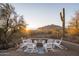 Relaxing backyard firepit area with seating and scenic mountain views at 7624 E Stagecoach Pass, Carefree, AZ 85377