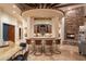 Custom bar with stone surround and leather barstools at 7624 E Stagecoach Pass, Carefree, AZ 85377