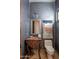Elegant powder room with ornate wooden vanity and decorative wall hanging at 7624 E Stagecoach Pass, Carefree, AZ 85377