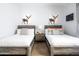 Guest bedroom with two twin beds, wood floors, and modern decor at 7624 E Stagecoach Pass, Carefree, AZ 85377