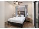 Bright bedroom with a queen-size bed, wood floors, and access to a private balcony at 7624 E Stagecoach Pass, Carefree, AZ 85377