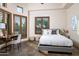 Bright bedroom with a queen-size bed, wood floors, and a workspace at 7624 E Stagecoach Pass, Carefree, AZ 85377