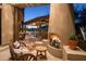 Rustic outdoor fireplace with comfortable seating area at 7624 E Stagecoach Pass, Carefree, AZ 85377