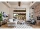 Bright and airy living room with a fireplace and access to a patio at 7624 E Stagecoach Pass, Carefree, AZ 85377