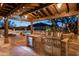 Outdoor kitchen under a pergola with mountain views at 7624 E Stagecoach Pass, Carefree, AZ 85377