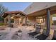 Relaxing patio with seating, outdoor kitchen, and pergola at 7624 E Stagecoach Pass, Carefree, AZ 85377