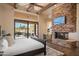 Primary bedroom with fireplace,sliding doors, and pool view at 7624 E Stagecoach Pass, Carefree, AZ 85377