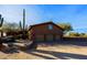 Three-car garage with desert landscape backdrop at 8505 E Morning Vista Rd, Scottsdale, AZ 85266