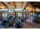 Rustic living room with exposed beams and a stone fireplace at 8505 E Morning Vista Rd, Scottsdale, AZ 85266