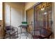 Private patio with wicker chairs and a small table at 9820 N Central Ave # 131, Phoenix, AZ 85020