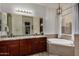 Elegant bathroom with double vanities, granite countertops, and a large soaking tub at 10241 E Ampere Ave, Mesa, AZ 85212