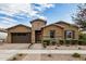 Single-story home with stone accents and a two-car garage at 10241 E Ampere Ave, Mesa, AZ 85212