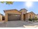 Tan two-story house with a brown garage door at 10241 E Ampere Ave, Mesa, AZ 85212