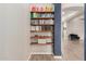 Built-in wooden shelving with cookbooks and decor at 10241 E Ampere Ave, Mesa, AZ 85212