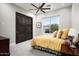 Cozy bedroom with a yellow bedspread, dark wood closet doors, and a window at 11821 N Sunset Vista Dr, Fountain Hills, AZ 85268