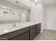 Double vanity bathroom with a large mirror and shower at 17867 W Encinas Ln, Goodyear, AZ 85338