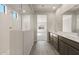 Modern bathroom with a walk-in shower and double vanity at 17867 W Encinas Ln, Goodyear, AZ 85338