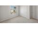 Spacious bedroom with carpet, window, and closet at 17867 W Encinas Ln, Goodyear, AZ 85338