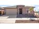Single-story house with a two-car garage and well-manicured landscaping at 17867 W Encinas Ln, Goodyear, AZ 85338