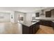 Open concept kitchen with island, granite countertops, and access to backyard at 17867 W Encinas Ln, Goodyear, AZ 85338