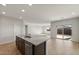 Modern kitchen with island, granite countertops and open to dining and living areas at 17867 W Encinas Ln, Goodyear, AZ 85338