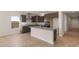 Modern kitchen with island, granite countertops, and dark wood cabinets at 17867 W Encinas Ln, Goodyear, AZ 85338