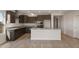 Open kitchen boasts an island, granite countertops, and stainless steel appliances at 17867 W Encinas Ln, Goodyear, AZ 85338