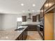 Spacious kitchen with dark wood cabinets, granite counters, and stainless steel appliances at 17867 W Encinas Ln, Goodyear, AZ 85338