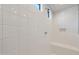 Clean shower with white tiles and built-in seat at 17867 W Encinas Ln, Goodyear, AZ 85338
