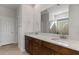 Double vanity bathroom with a large mirror and shower at 17869 W Getty Dr, Goodyear, AZ 85338