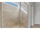 Large shower with glass enclosure and window at 17869 W Getty Dr, Goodyear, AZ 85338