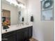 Well-lit bathroom featuring a sleek vanity with ample storage and a large mirror, offering a functional space at 20698 E Marsh Rd, Queen Creek, AZ 85142