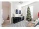 Comfortable living space featuring a modern entertainment setup, and a festive Christmas tree creating a cozy ambiance at 20698 E Marsh Rd, Queen Creek, AZ 85142