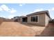 Spacious backyard awaiting landscaping, with a patio area and privacy fence at 22500 E Orchard Ln, Queen Creek, AZ 85142