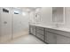 Elegant bathroom with double vanities, a glass-enclosed shower, and modern fixtures at 22500 E Orchard Ln, Queen Creek, AZ 85142