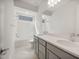 Contemporary bathroom showcases a dual sink vanity and a shower-tub combo at 22500 E Orchard Ln, Queen Creek, AZ 85142
